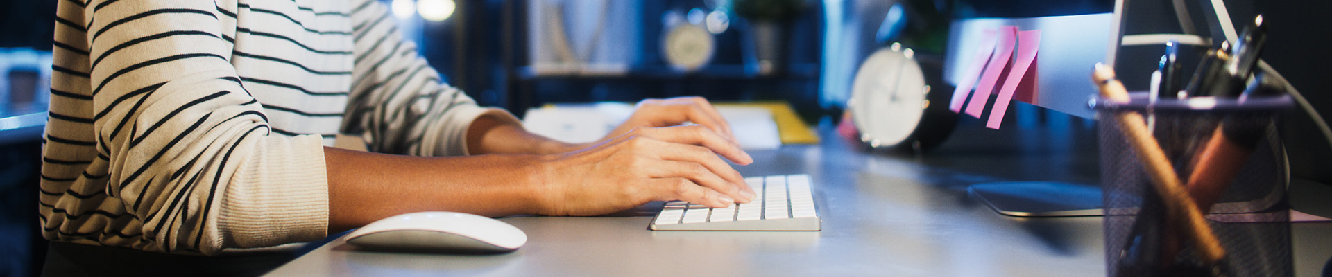 Asian business woman type keyboard, work late night using desktop computer in home office. Hard working business people, work from home or internet information technology concept. Banner size